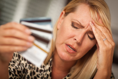 Upset Woman Holding Her Many Credit Cards